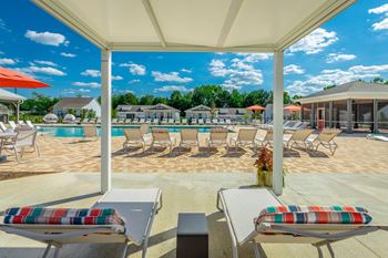 Poolside cabanas with chaise lounge seating
